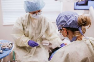 dentists working on patient's smile