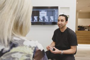 dentist talking to patient about dentures